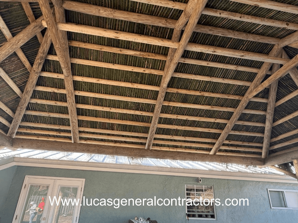 Rustic thatched roof and wood beams attached to house